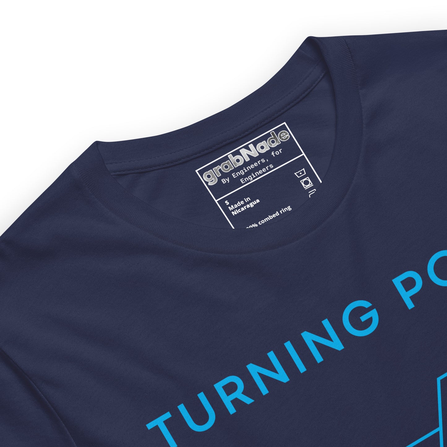 Close up of white t-shirt featuring "Turning Point" text and an Ra 6.3 surface finish machining symbol.
