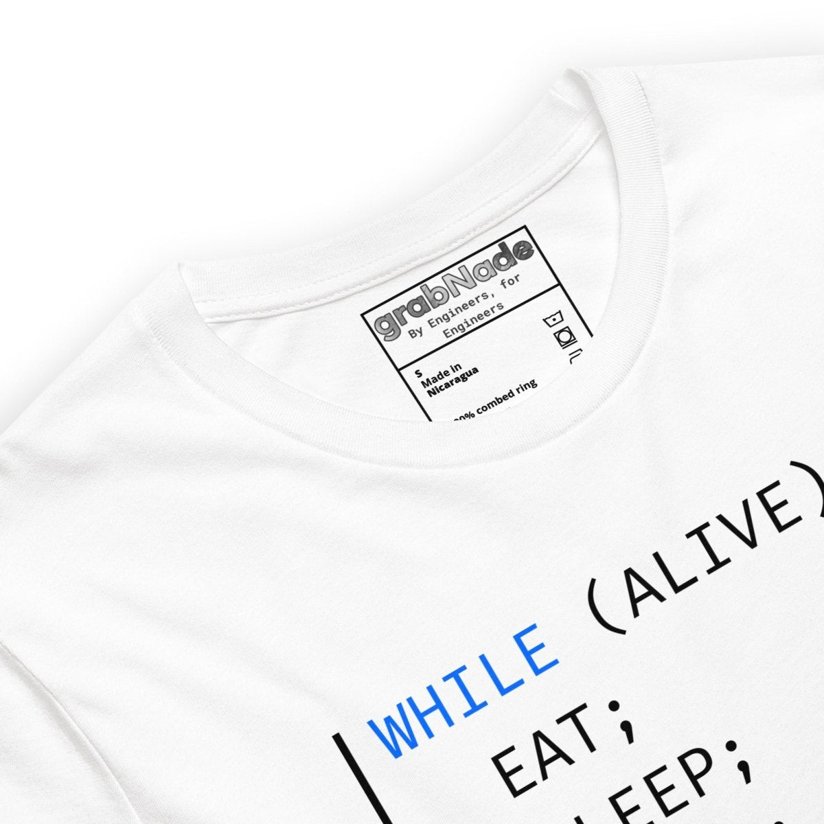 Close up of white t-shirt with "WHILE ALIVE DO EAT SLEEP DEBUG END_WHILE" programmer code graphic.