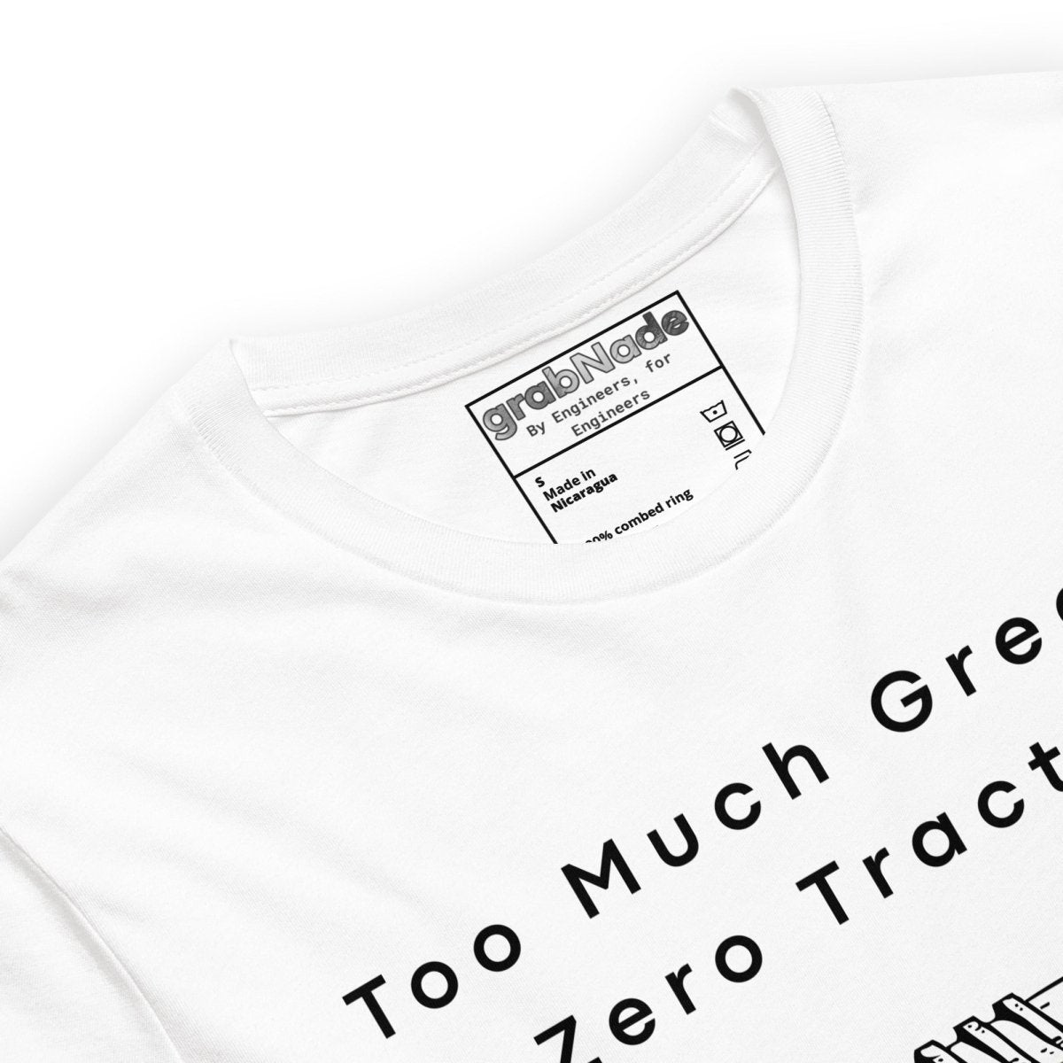 Close up of white t-shirt featuring "Too much grease. Zero traction" text and mechanical drive graphic.