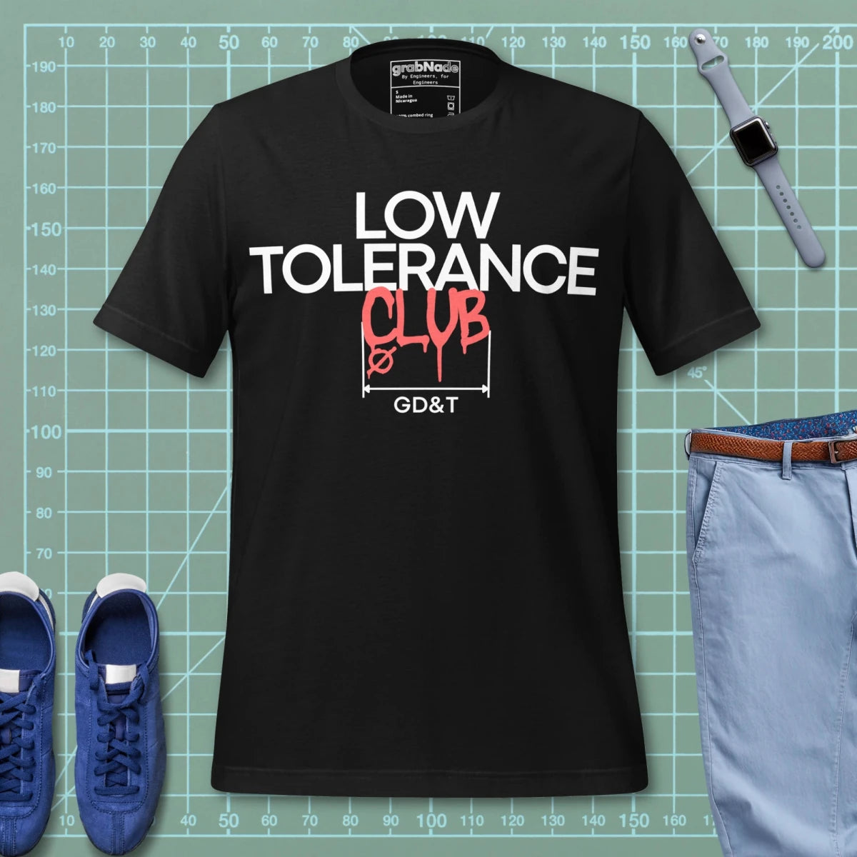 Black t-shirt with "LOW TOLERANCE CLUB" dripping precision tolerance numbers graphic.