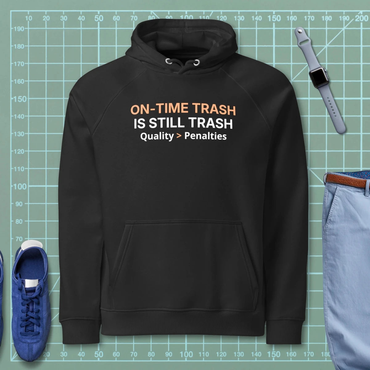 Black eco raglan hoodie featuring "ON-TIME Trash is still Trash" for manufacturing and quality engineers.