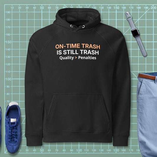 Black eco raglan hoodie featuring "ON-TIME Trash is still Trash" for manufacturing and quality engineers.