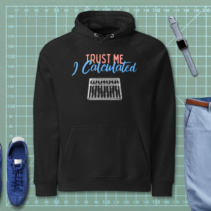 Black hoodie "Trust Me I calculated" with technical abacus line-art graphic.