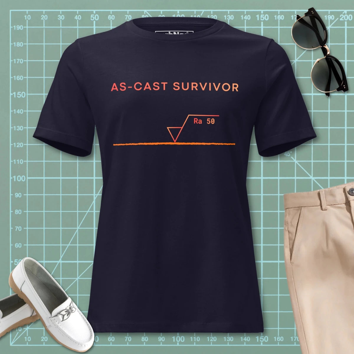 Women's navy t-shirt featuring "As-Cast Survivor" text & Ra 50 surface roughness symbol for eng.