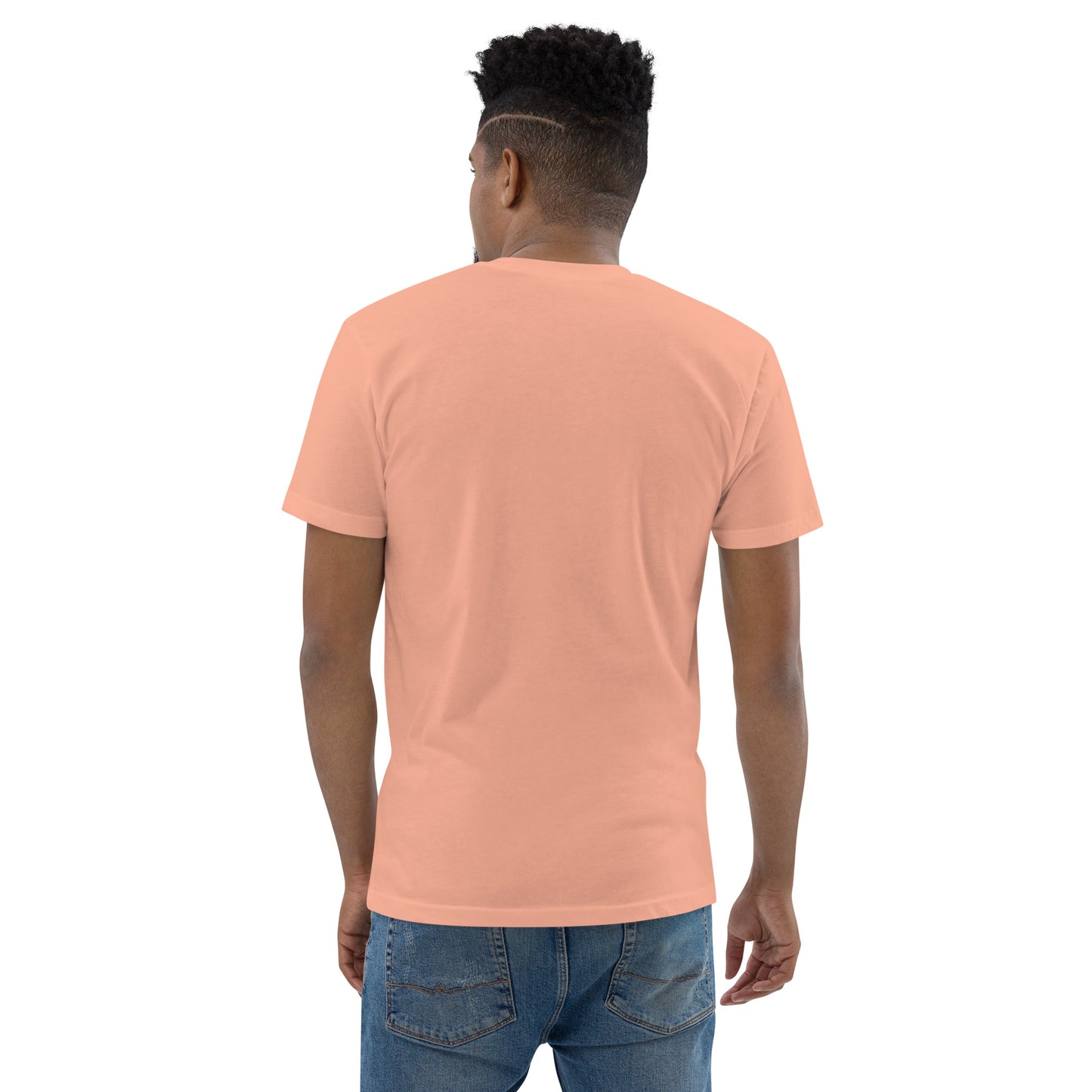 Product mockup. Man with short hair and beard wearing a plain desert pink fitted t-shirt and black pants, back view.