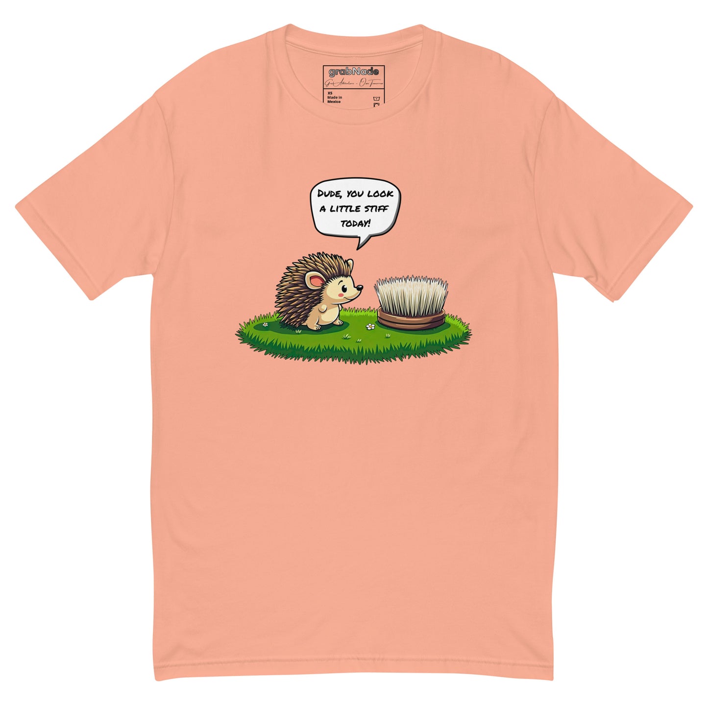 Product mockup. Desert pink t-shirt on a hanger printed with a cartoon hedgehog talking to a round brush and the caption, "Dude, you look a little stiff today!"