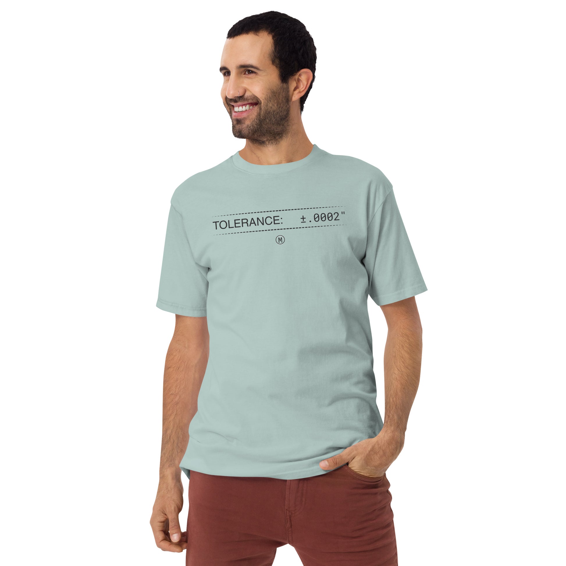 Man in heavyweight blue premium t-shirt with text "TOLERANCE: ±.0002" for mechanical engineers.