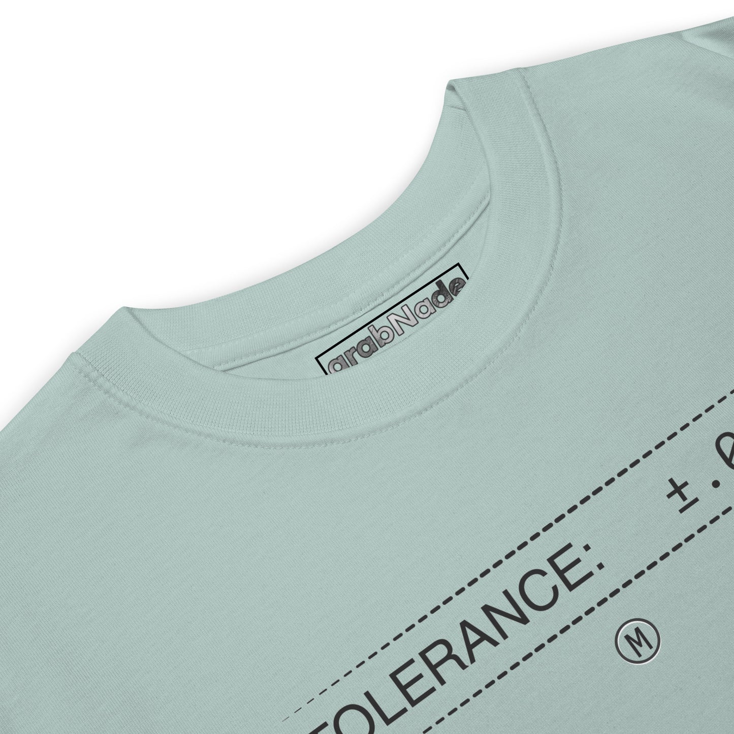 Closeup heavyweight blue premium t-shirt with text "TOLERANCE: ±.0002" for mechanical engineers.