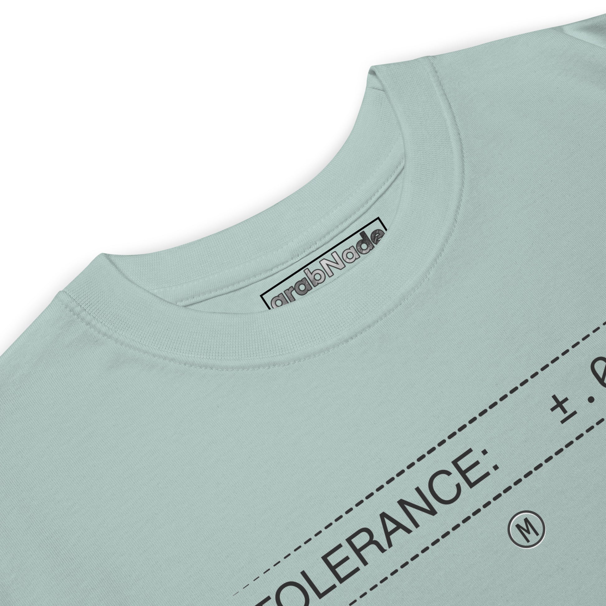 Closeup heavyweight blue premium t-shirt with text "TOLERANCE: ±.0002" for mechanical engineers.