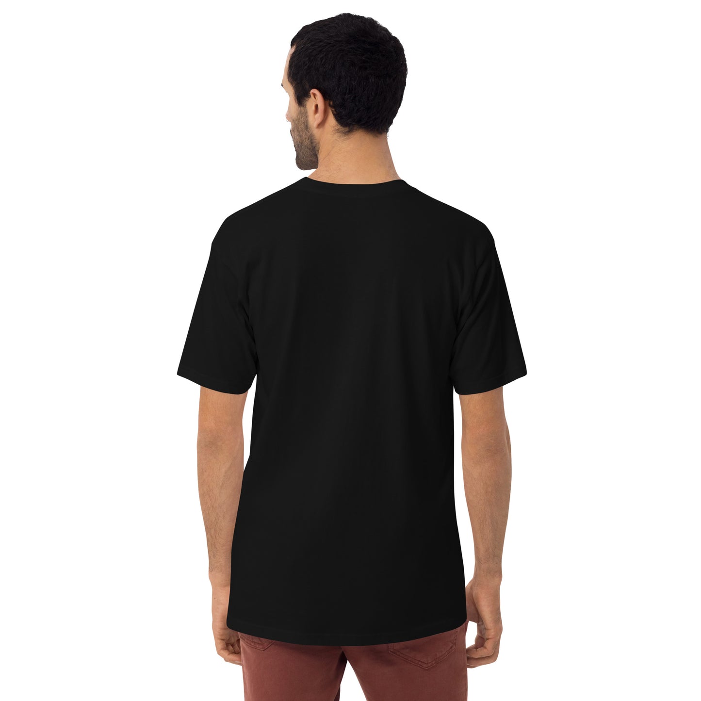 Product mockup. Man with short curly hair shown from behind, wearing a plain black heavyweight t-shirt and brick-colored pants, straight fit.