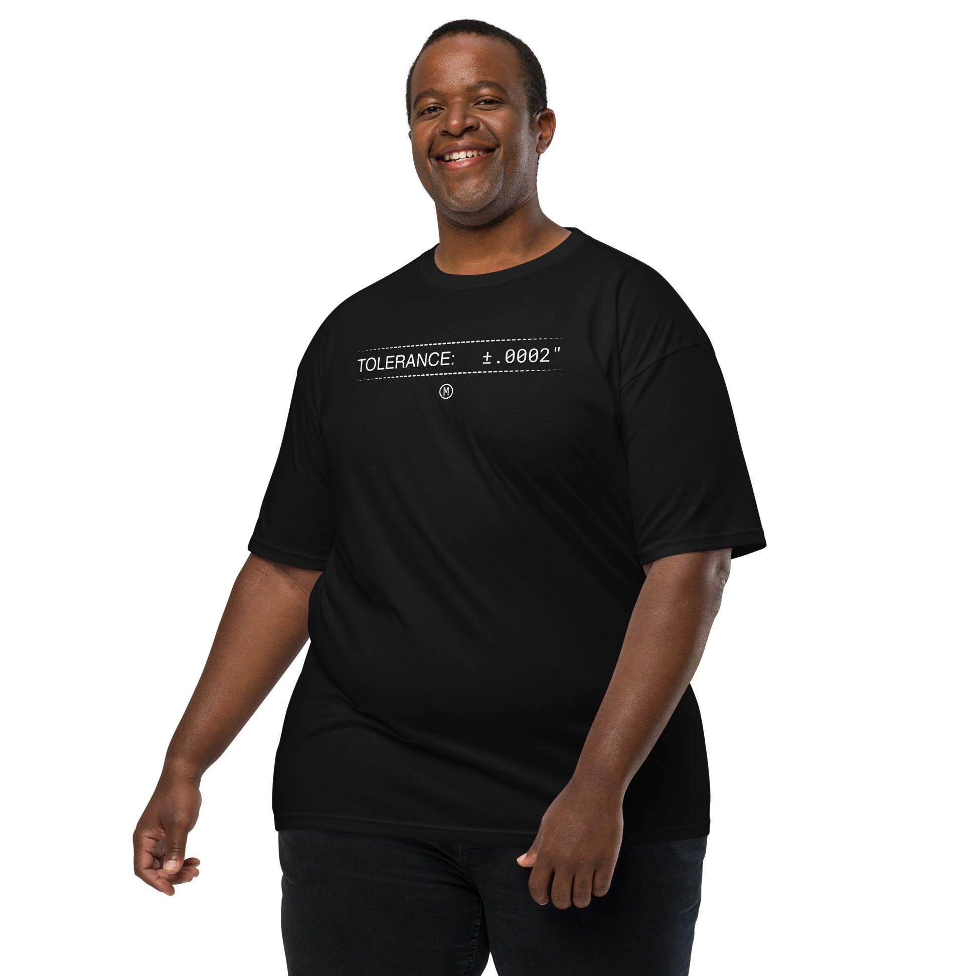 2XL man in heavyweight black premium t-shirt with white text "TOLERANCE: ±.0002" for mechanical engineers.
