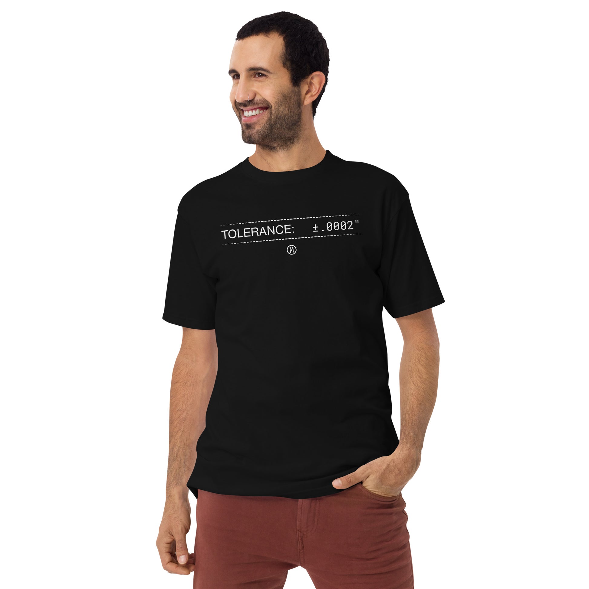 Man in heavyweight black premium t-shirt with white text "TOLERANCE: ±.0002" for mechanical engineers.