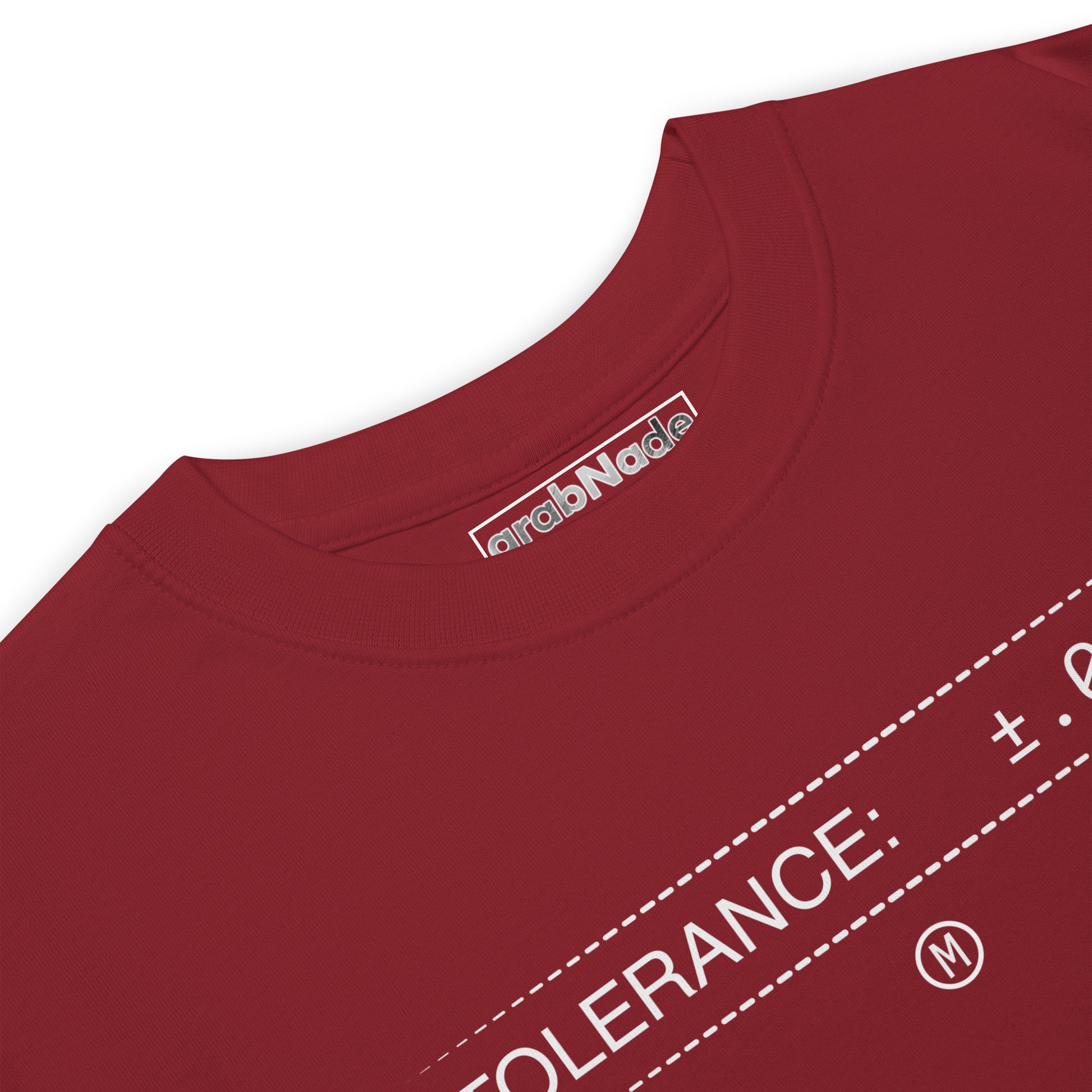 Closeup heavyweight red premium t-shirt with white text "TOLERANCE: ±.0002" for mechanical engineers.