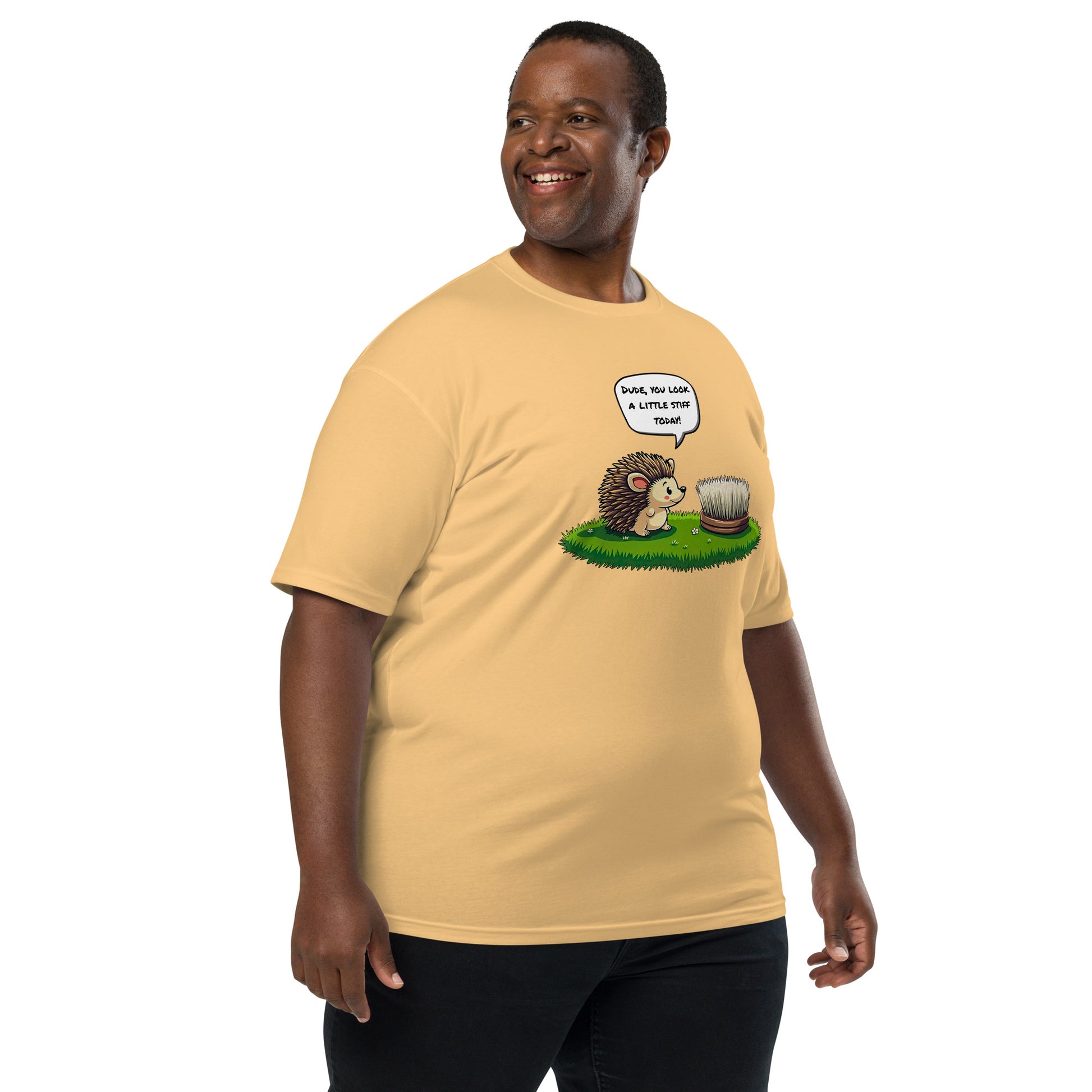 Product mockup. Plus-size man wearing a pale yellow heavyweight t-shirt with a cartoon hedgehog talking to a brush and the caption "Dude, you look a little stiff today!"