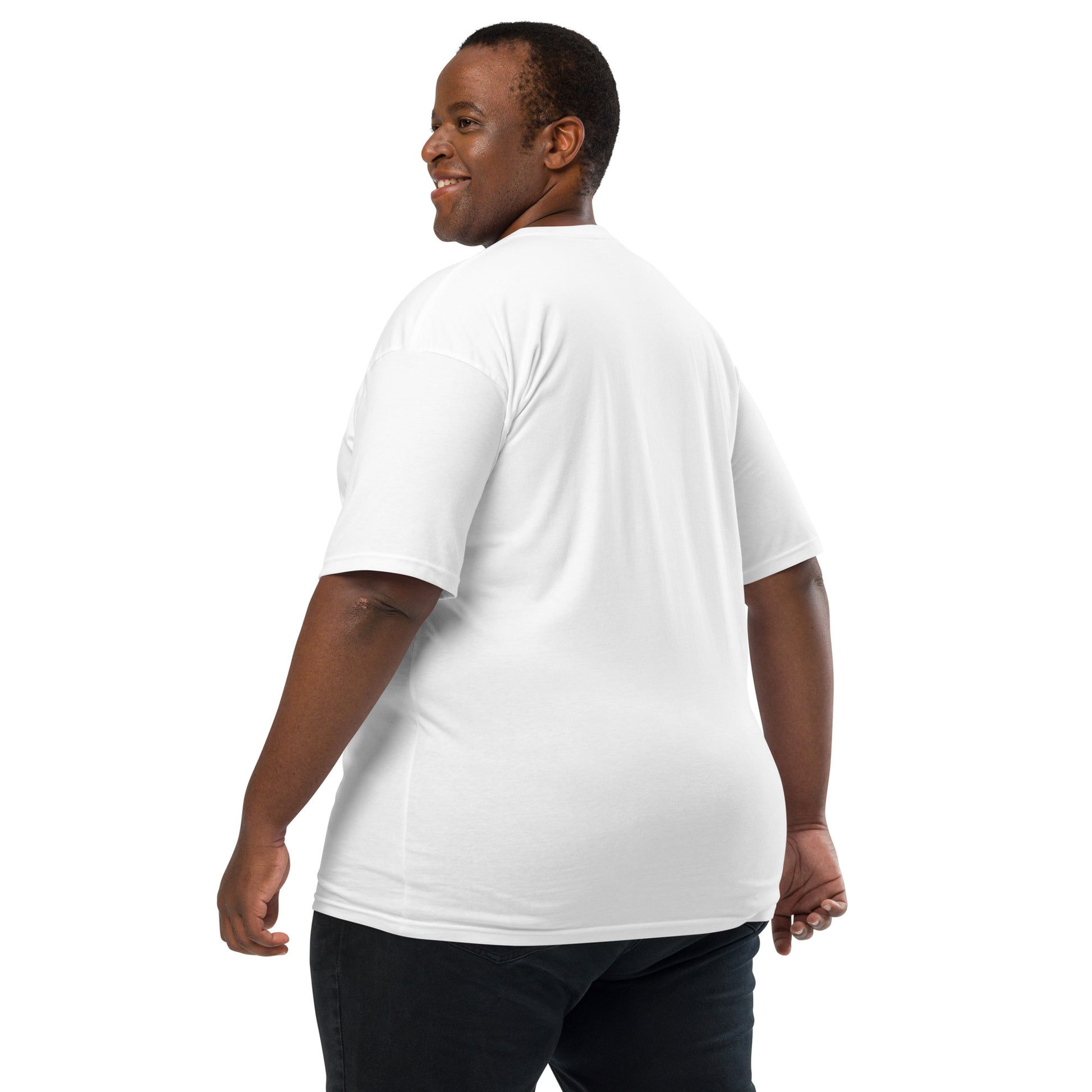 Product mockup. Man with short curly hair shown from behind, wearing a plain white heavyweight t-shirt and brick-colored pants.