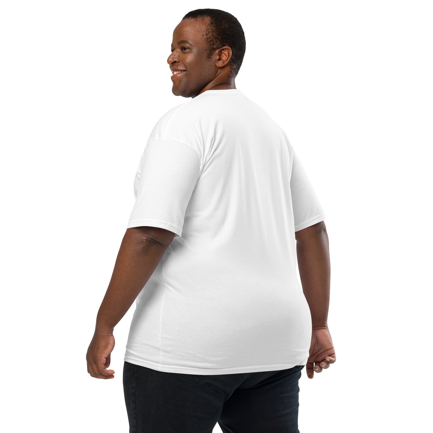 Product mockup. Man with short curly hair shown from behind, wearing a plain white heavyweight t-shirt and brick-colored pants.