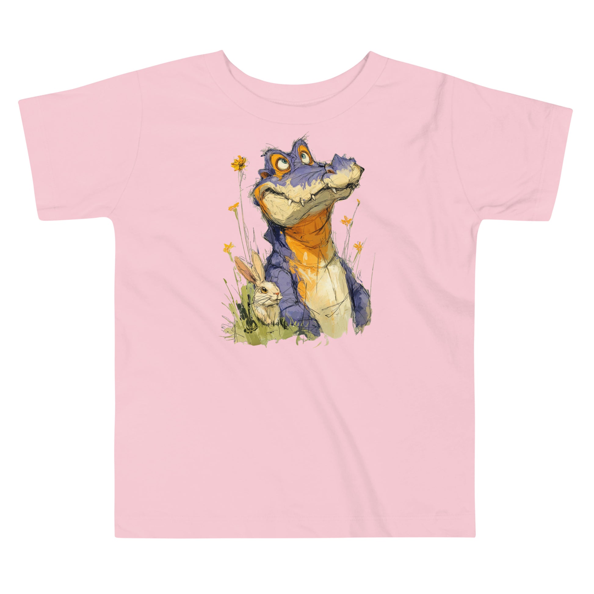 Product mockup. A light pink toddler t-shirt with a large, playful illustration on the front showing a purple and orange cartoon dinosaur among yellow wildflowers, with a small rabbit sitting in the grass next to it.