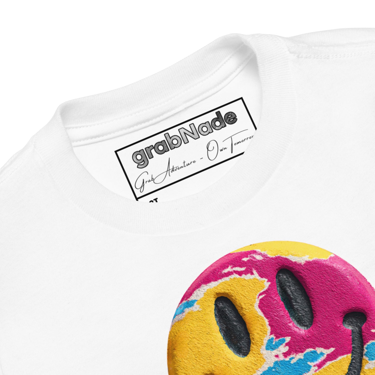 Product mockup. Close-up of a white t-shirt collar, partial blue and yellow smiley face graphic, showing a printed grabNade label.