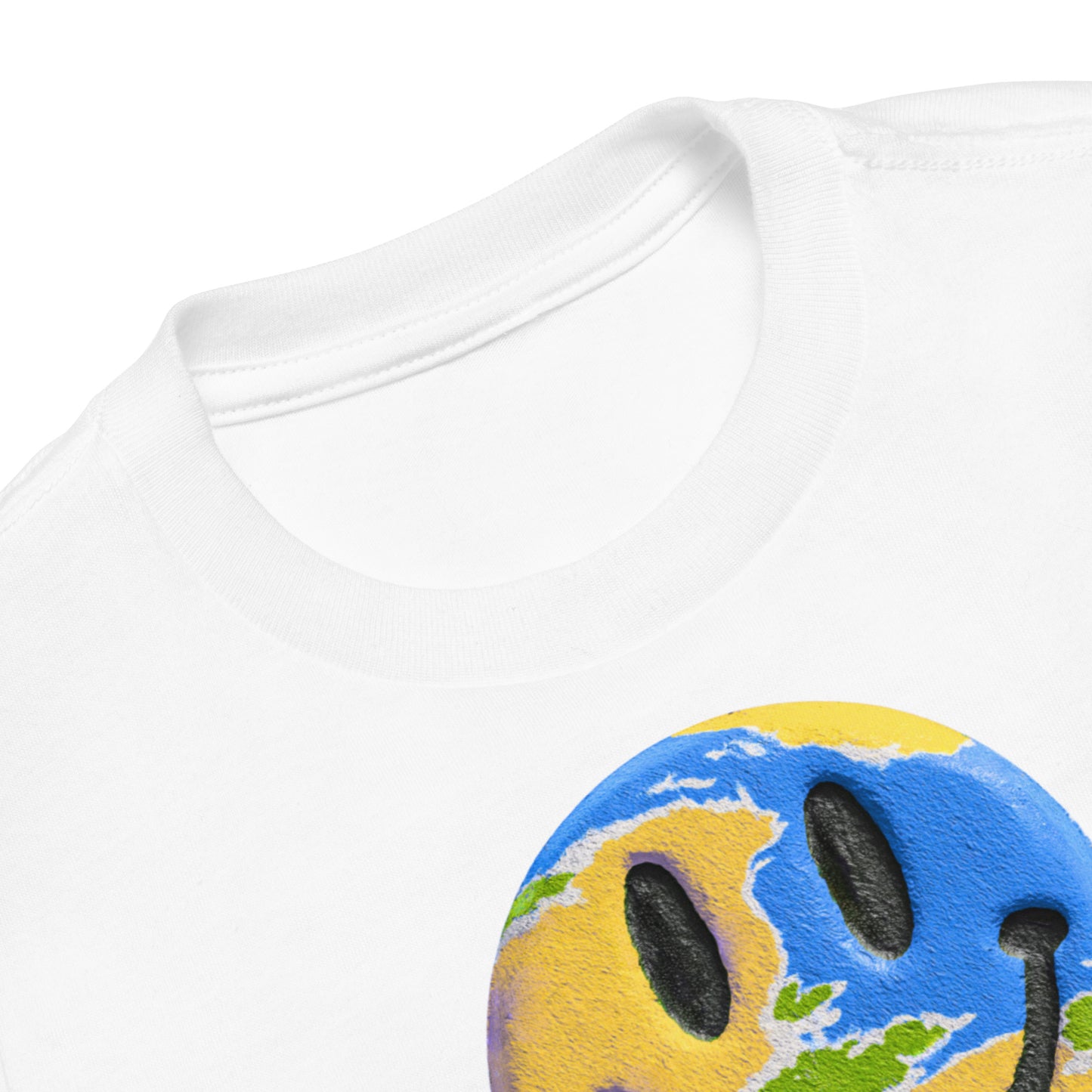 Product mockup. Close-up of a white t-shirt collar, partial blue and yellow smiley face graphic, showing a printed grabNade label.
