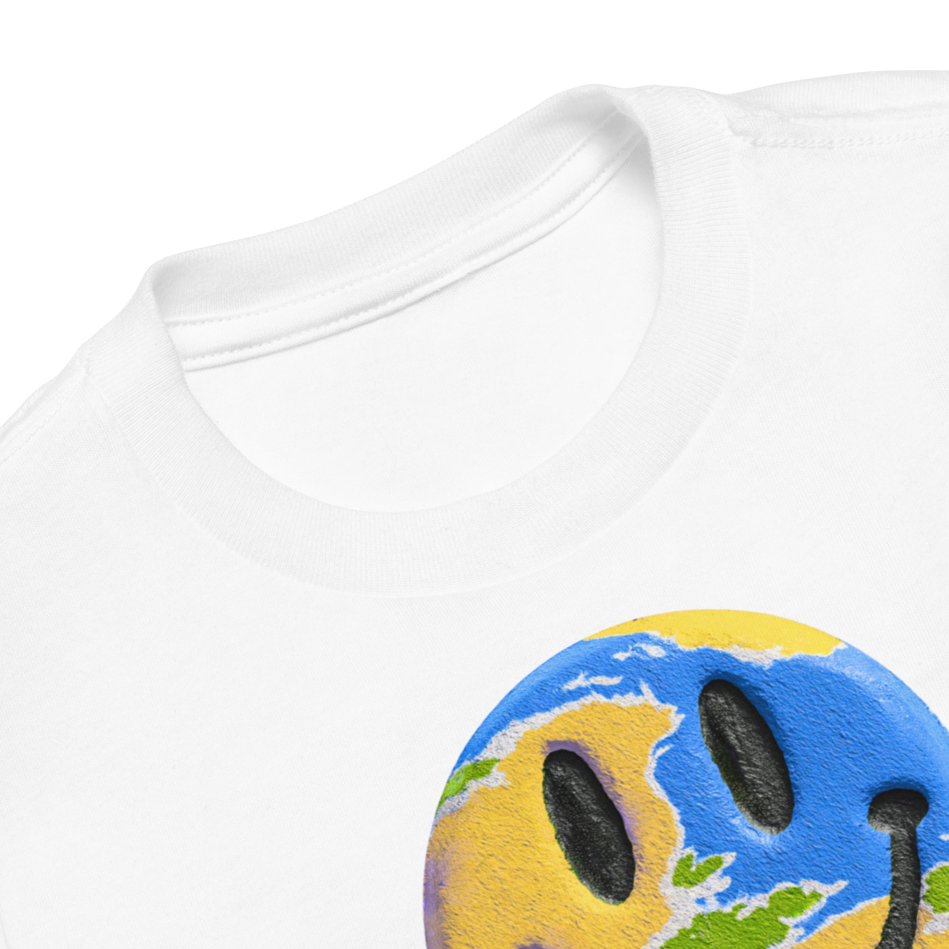 Product mockup. Close-up of a white t-shirt collar, partial blue and yellow smiley face graphic, showing a printed grabNade label.