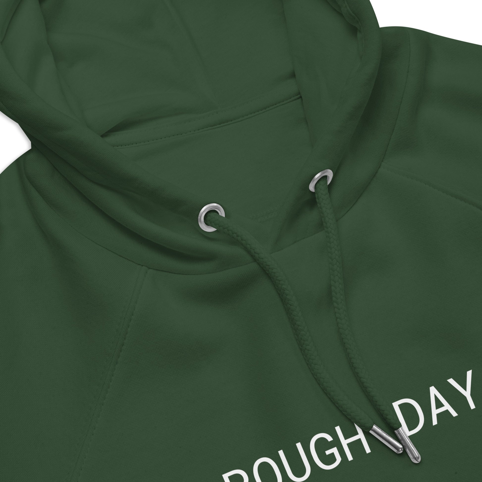 Closeup of top front view of green hoodie with partial view of the white text "Rough Day".