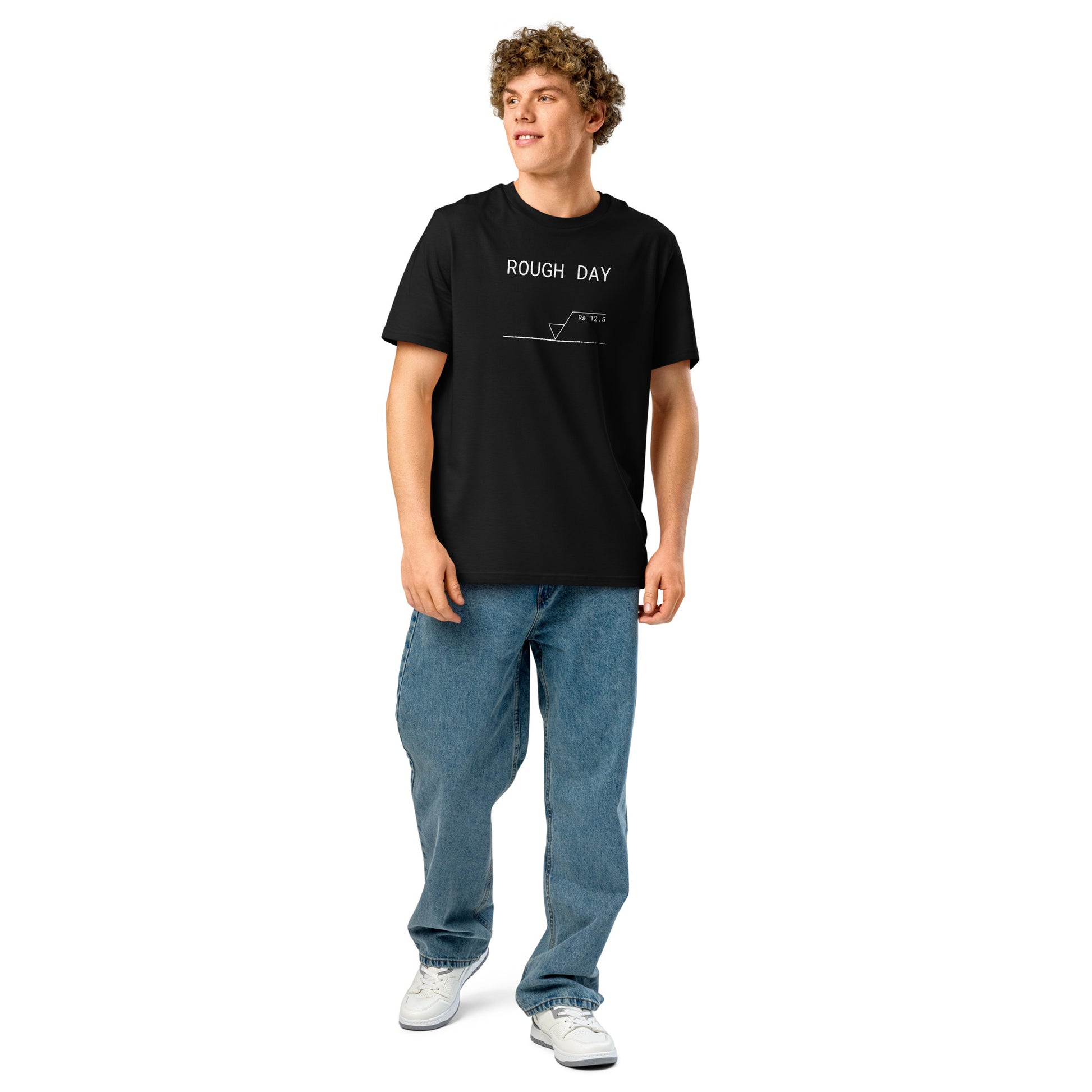 Man wearing black GOTS organic tee with white roughness symbol and "ROUGH DAY (Ra 12.5)" text.