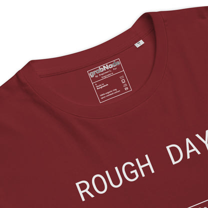 Closeup of red GOTS organic tee with white roughness symbol and "ROUGH DAY (Ra 12.5)" text.