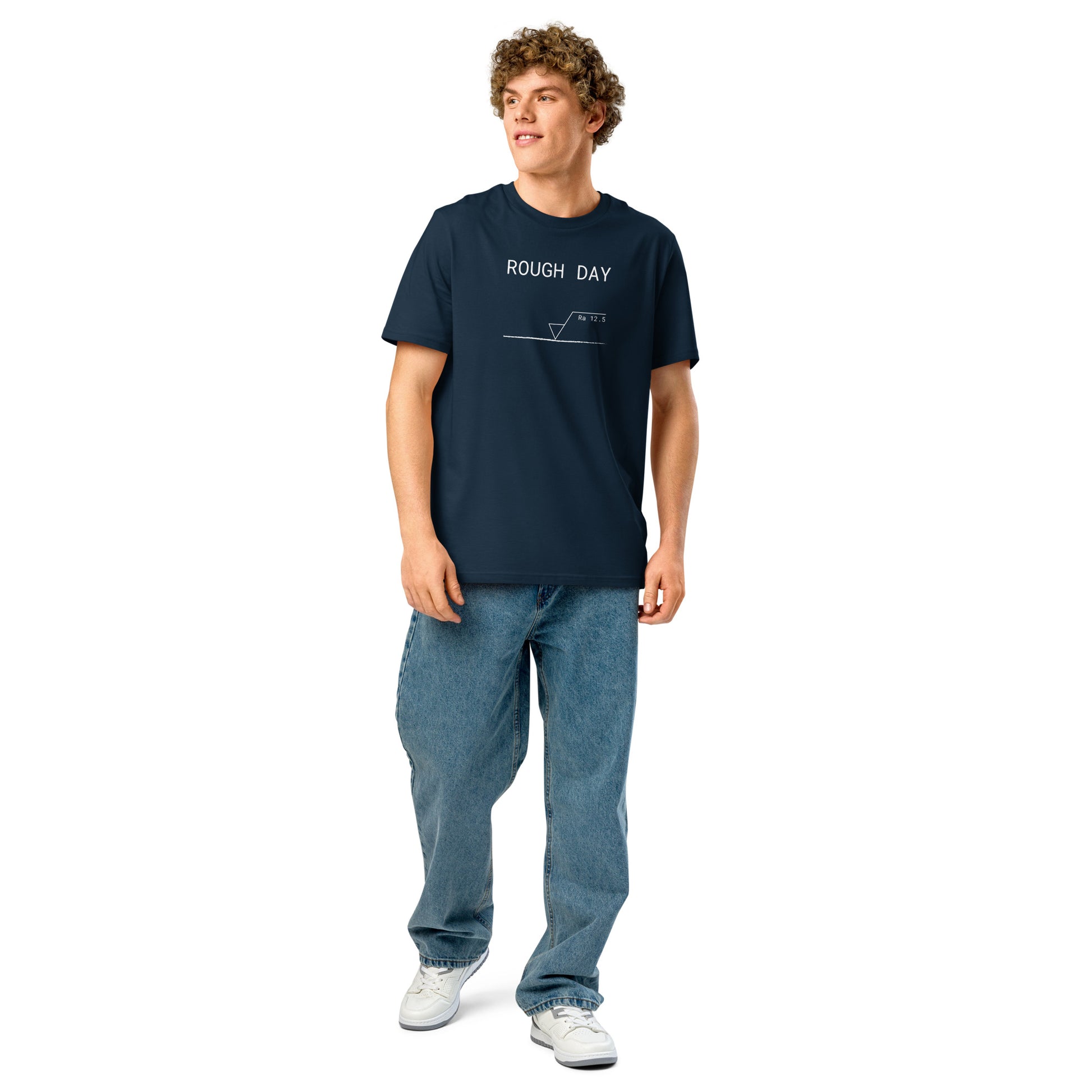 Man wearing navy GOTS organic tee with white roughness symbol and "ROUGH DAY (Ra 12.5)" text.