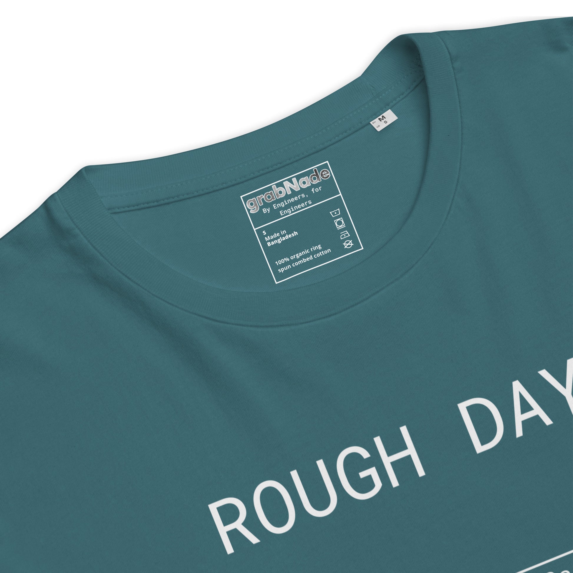 Closeup of blue GOTS organic tee with white roughness symbol and "ROUGH DAY (Ra 12.5)" text.