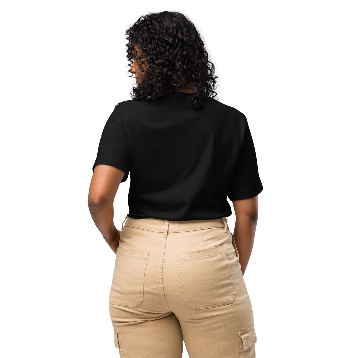 Product mockup. Woman standing with her back to the camera, wearing a plain black t-shirt and tan pants with back pockets.