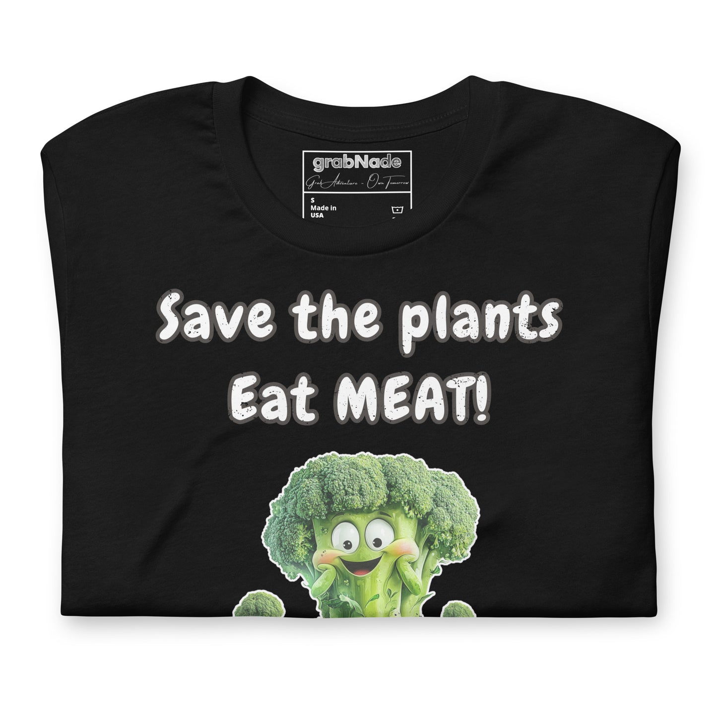 Product mockup. Black t-shirt with bold white text “Save the plants, Eat MEAT!” and a smiling cartoon broccoli character.