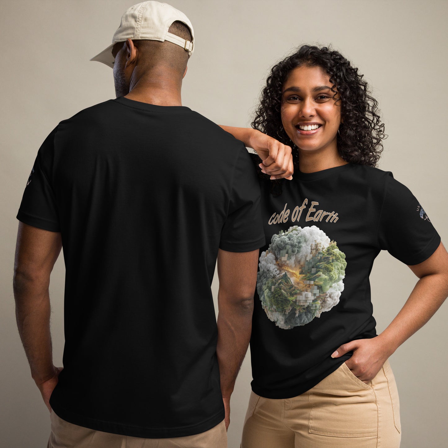 Product mockup. A man and woman stand together; the woman wears a "code of Earth" t-shirt with a pixelated earth graphic, while the man shows the back of a plain black t-shirt.