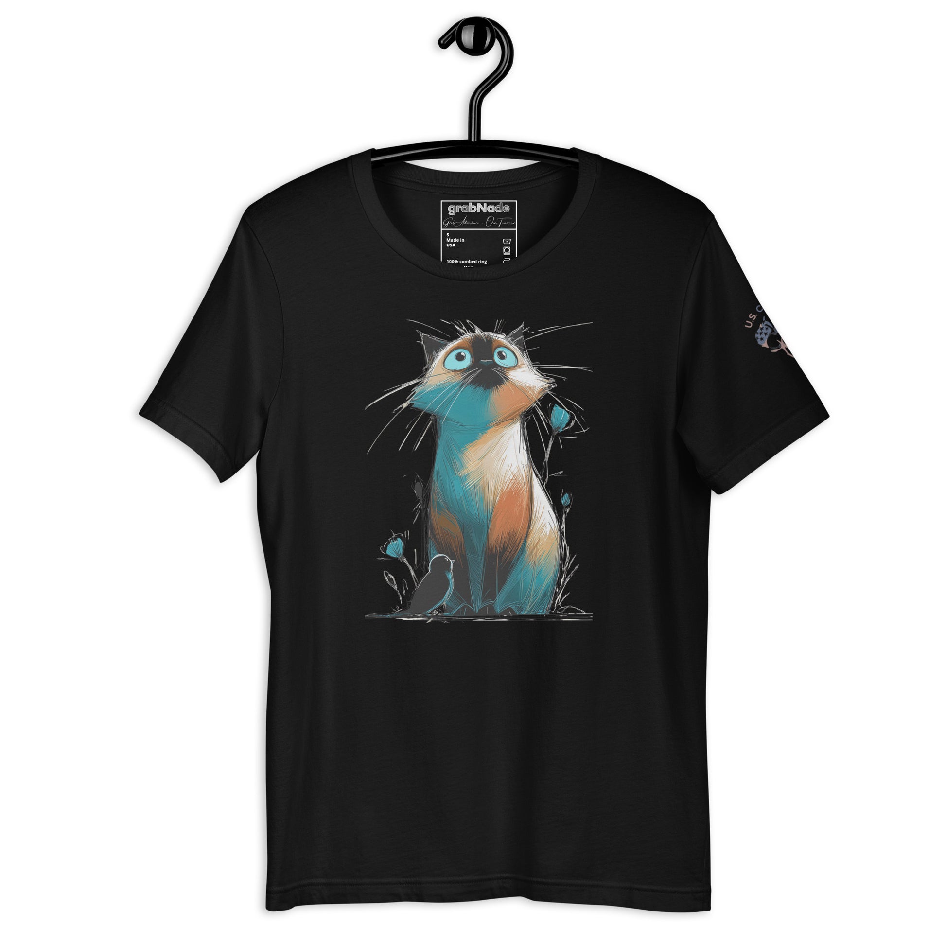 Product mockup. Black t-shirt on a hanger with a vivid illustration of a blue, orange, and white cartoon cat with bright blue eyes.