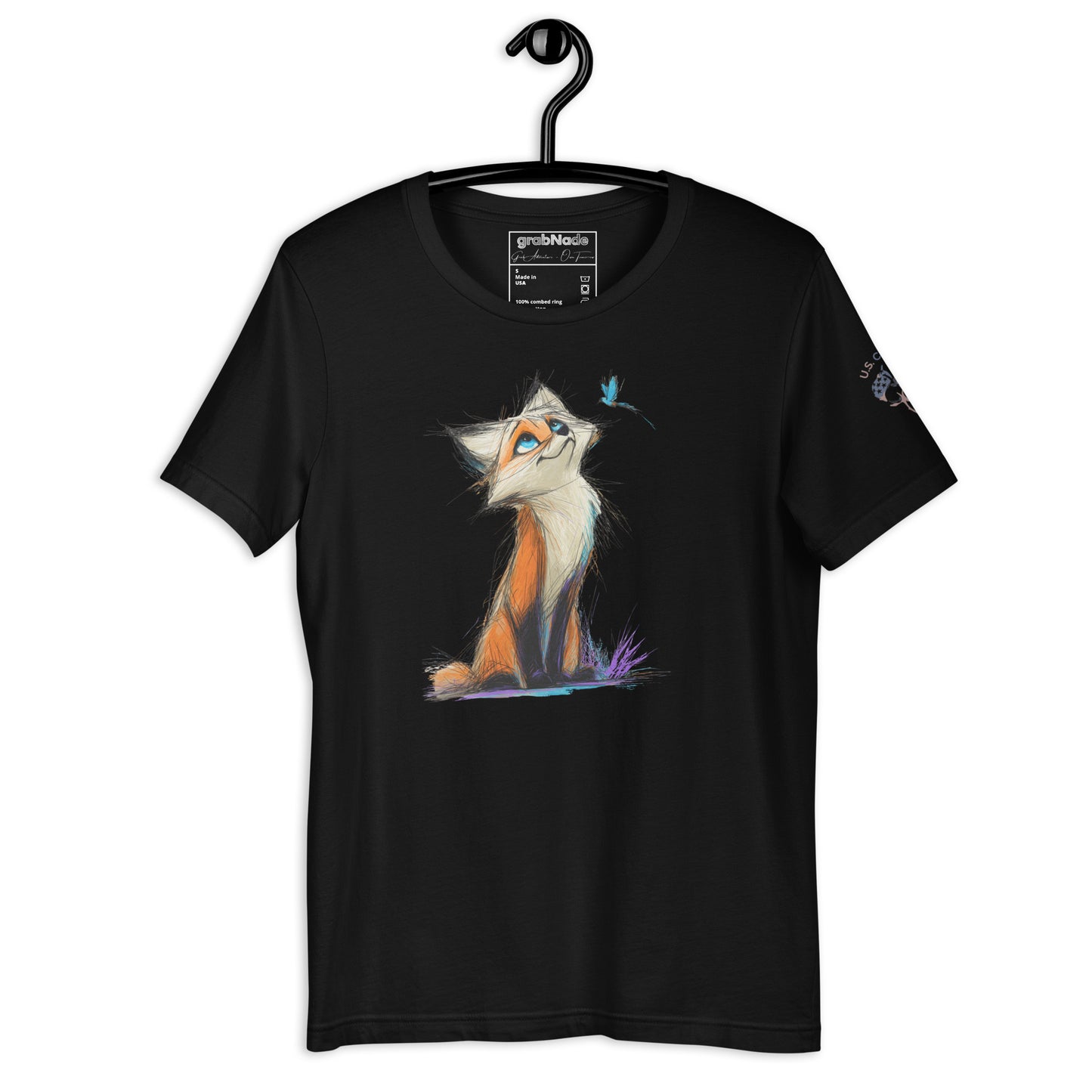 Product mockup. Black t-shirt on a hanger, decorated with a colorful sketch-style fox sitting on grass, looking up at a small blue bird.