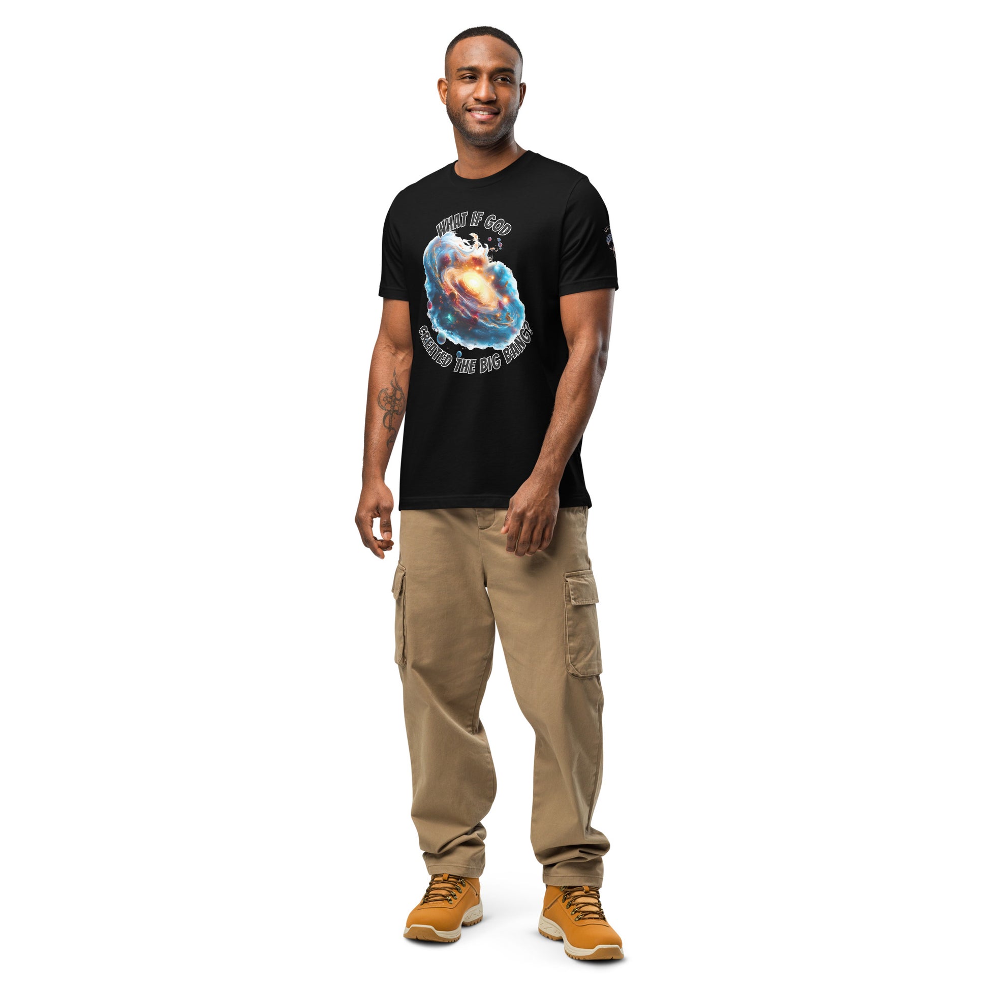 Product mockup. A man stands wearing a black t-shirt with a colorful galaxy swirl and the phrase "WHAT IF GOD CREATED THE BIG BANG?" above and below the design.