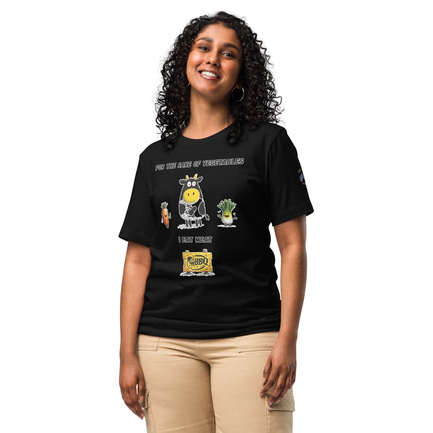 Product mockup. A woman stands wearing a black t-shirt with a cow, a carrot, and a lettuce cartoon, BBQ sign, and the phrase "For the sake of vegetables I eat meat."
