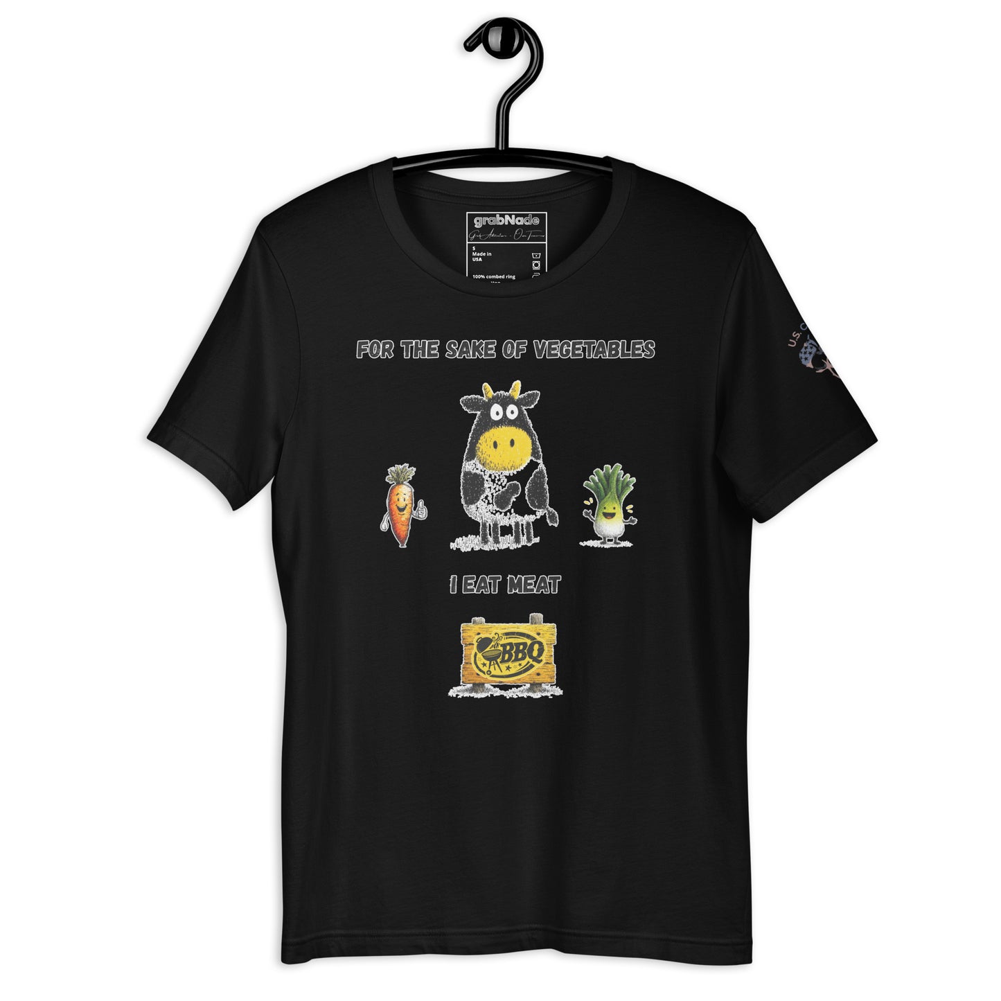 Product mockup. Black t-shirt on a hanger featuring cartoon characters of a cow, a carrot, and a lettuce, with a BBQ sign and the phrase "For the sake of vegetables I eat meat."