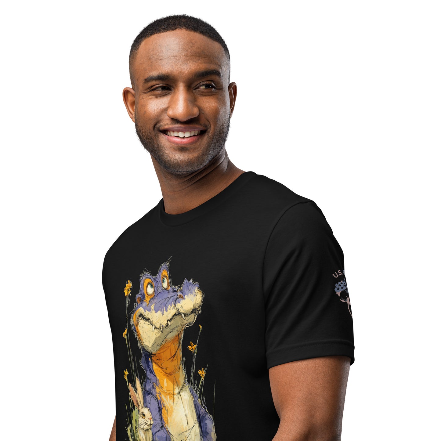 Product mockup. Close-up of a black t-shirt featuring an expressive purple, blue, and orange alligator drawing, with a "U.S. Cotton" badge on the sleeve.