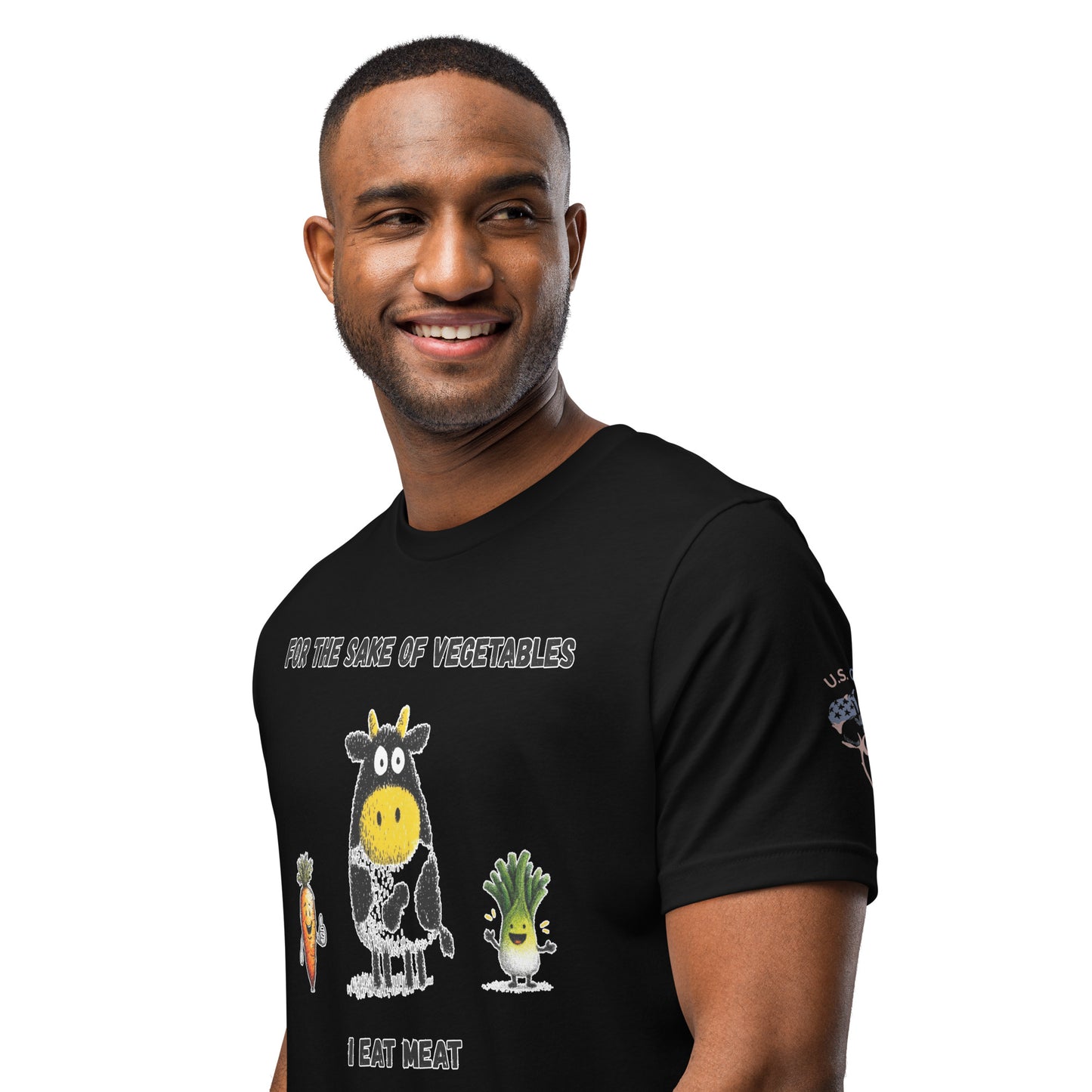 Product mockup. A man wears a black t-shirt with the text "For the sake of vegetables I eat meat" and illustrated cartoon animals and vegetables.