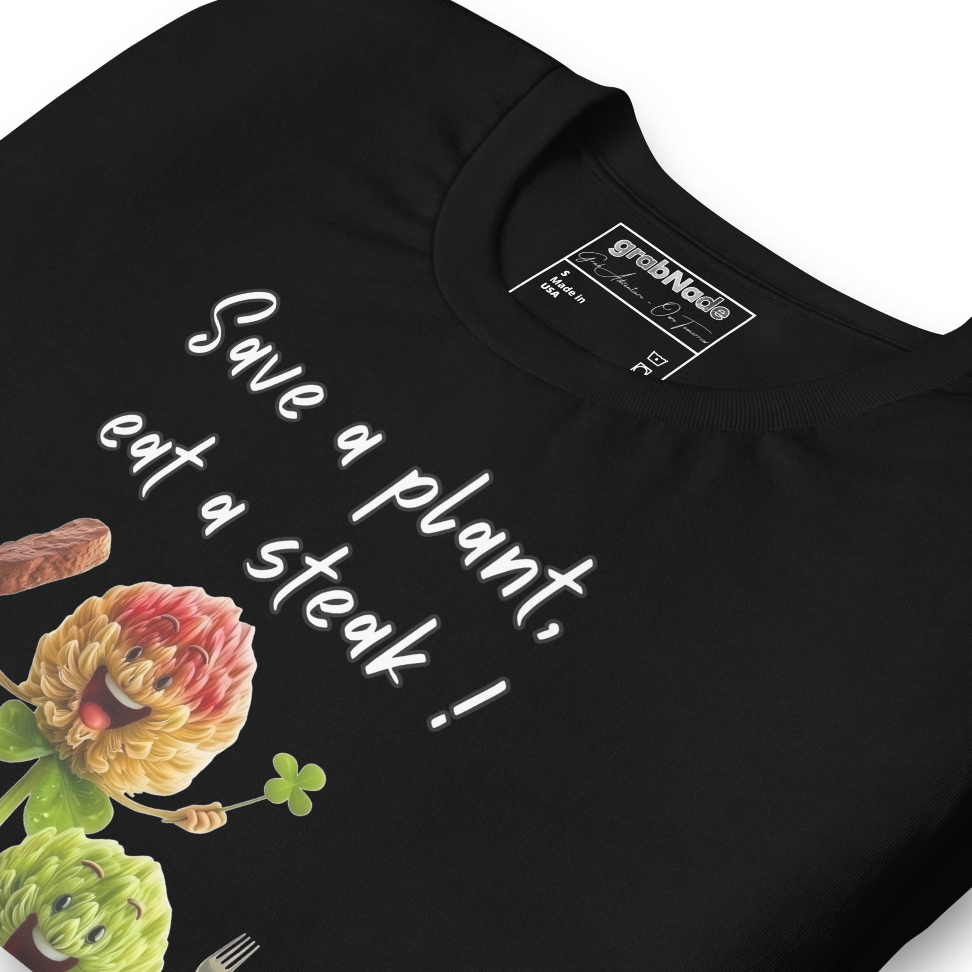 Product mockup. Close-up of a black t-shirt with the words "Save a plant, eat a steak!" and two cartoon flower characters holding utensils and a steak.