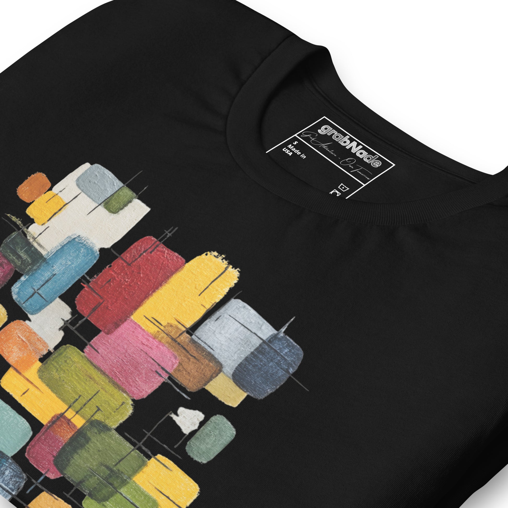 Product mockup. Close-up of a black t-shirt featuring an abstract pattern of rectangles in red, blue, yellow, green, and white.