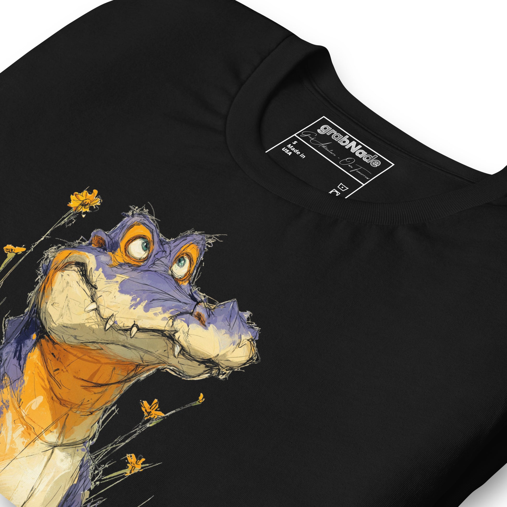 Product mockup. Close-up of a black t-shirt with a sketch-style purple and orange alligator or dragon adorned with yellow flowers.