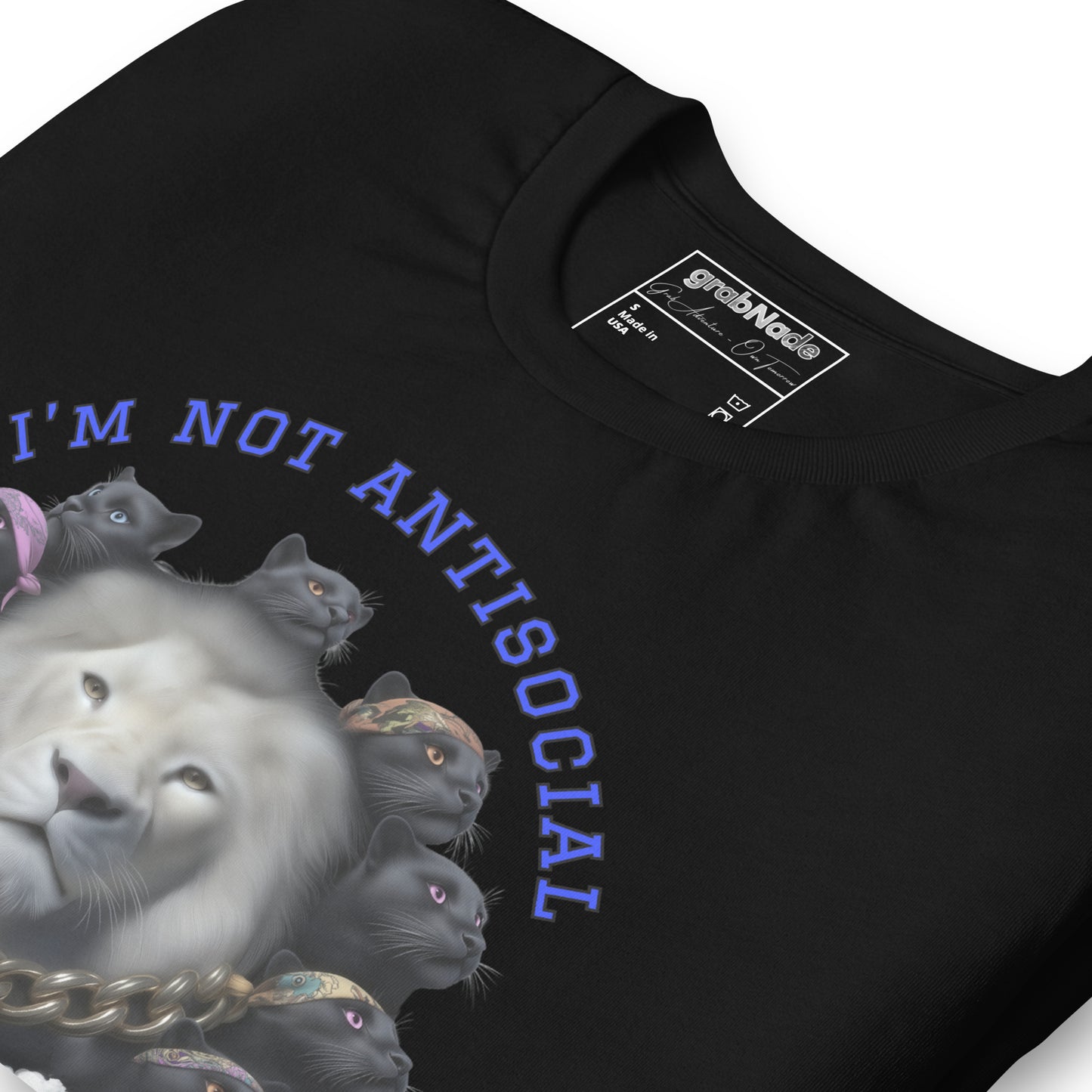 Product mockup. Close-up of a black t-shirt with a white lion surrounded by black cats wearing colorful bandanas and the phrase "I'M NOT ANTISOCIAL."