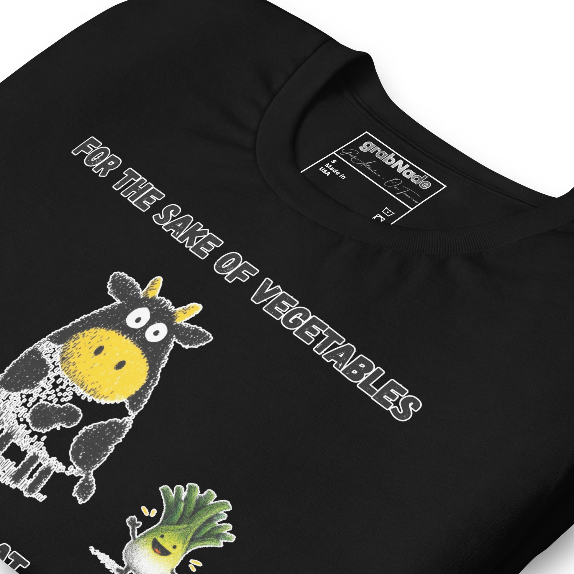 Product mockup. Close-up of black T-shirt with smiling vegetable characters and cow, text "FOR THE SAKE OF VEGETABLES I EAT MEAT."