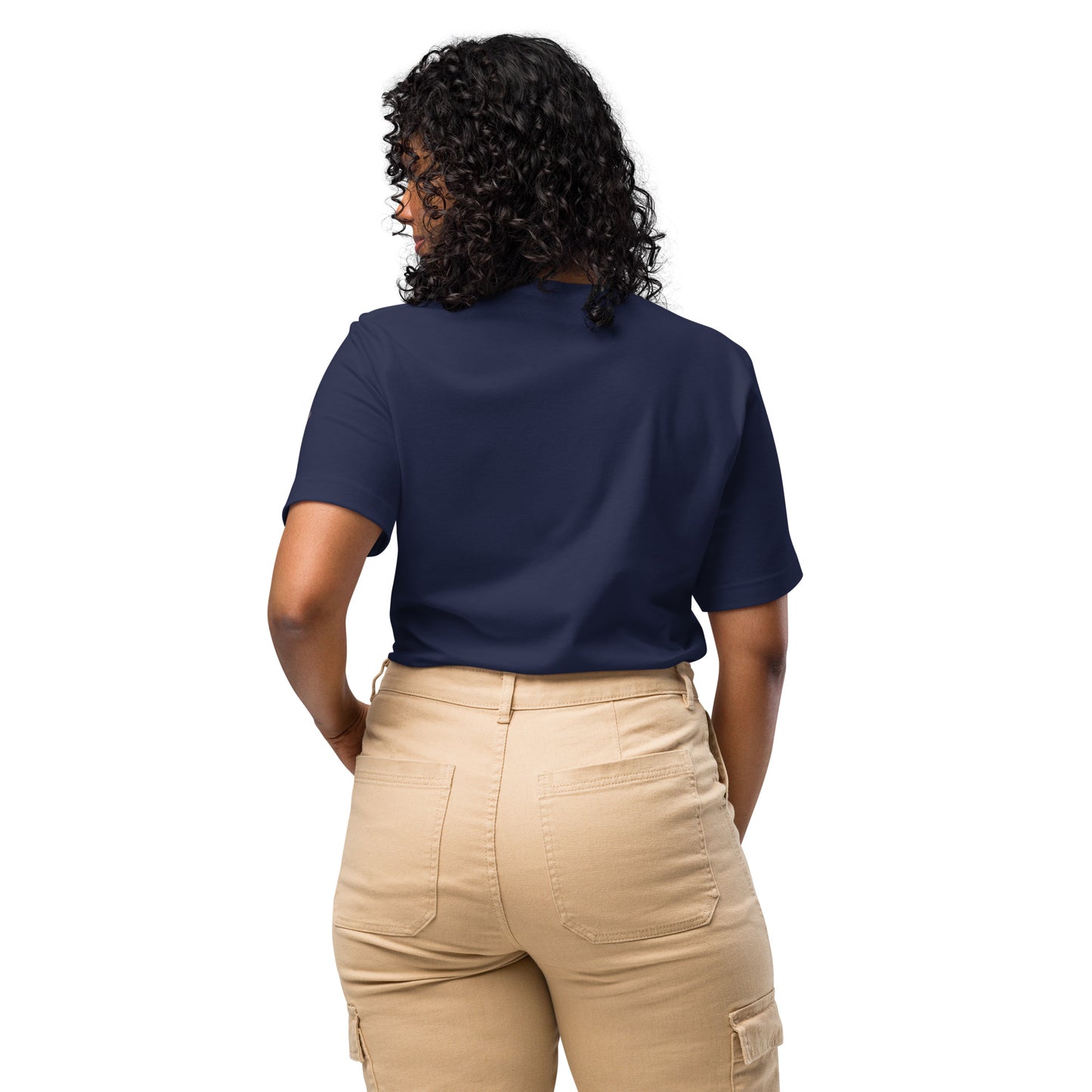Product mockup. Back view of a woman wearing a plain navy blue T-shirt and khaki pants, hands on hips.