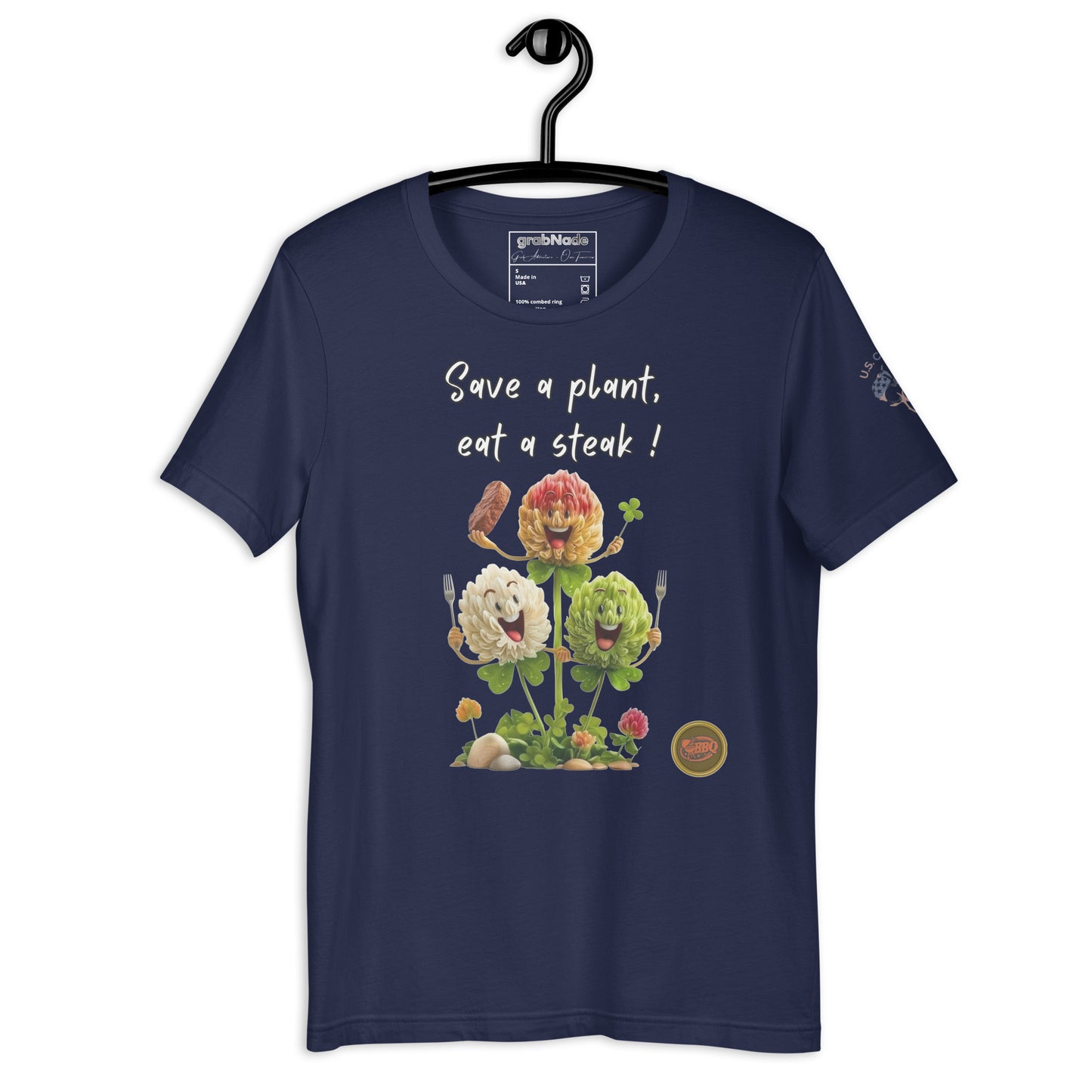 Product mockup. Navy blue t-shirt displayed on a hanger, printed with the phrase “Save a plant, eat a steak!” above three smiling cartoon flowers.