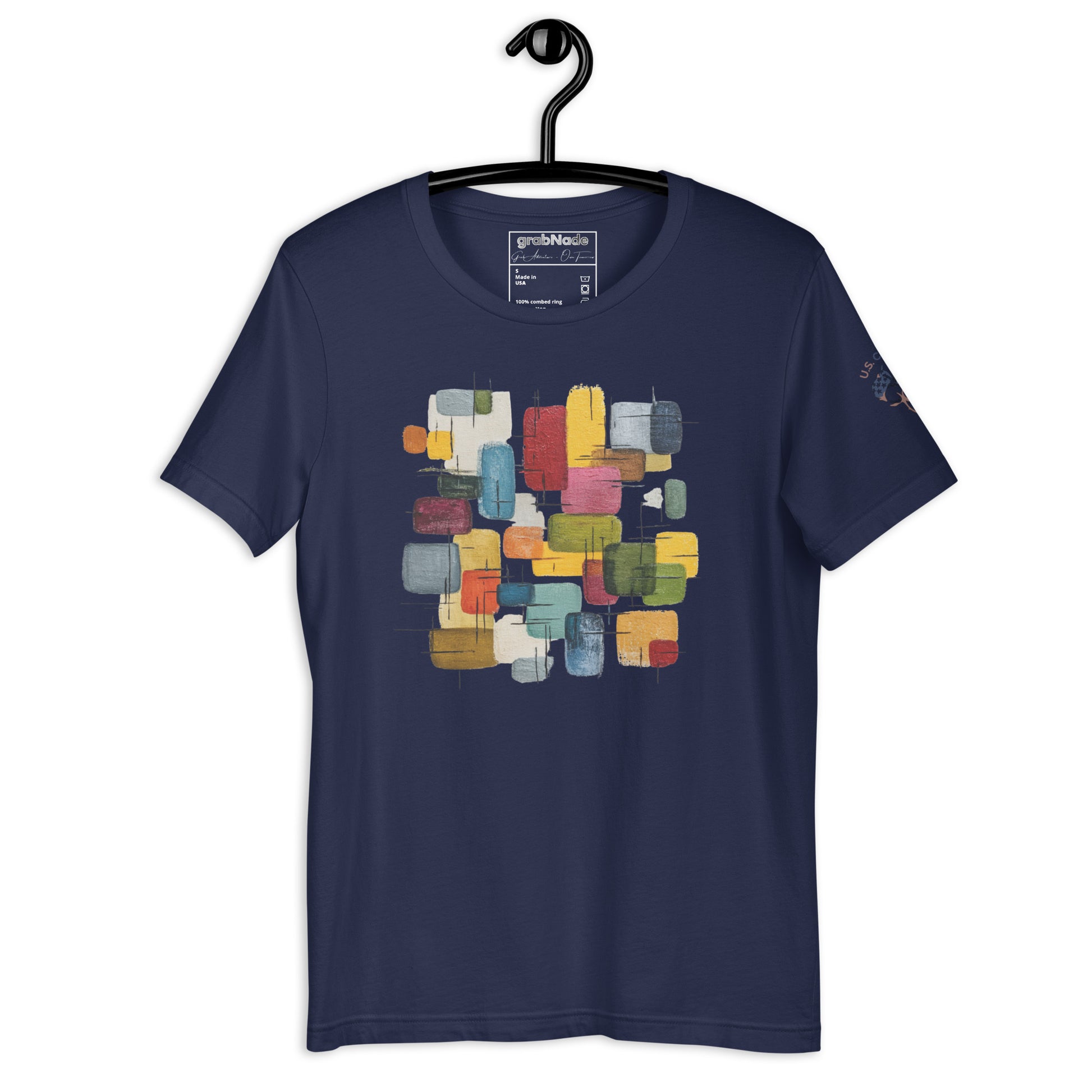 Product mockup. Navy blue t-shirt on a hanger, featuring an abstract geometric block pattern in various colors on the chest.