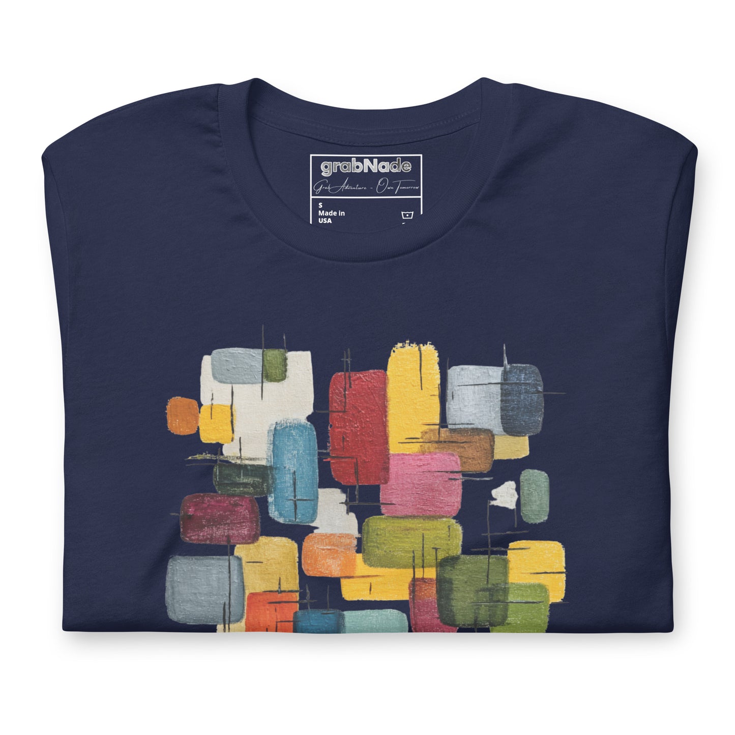 Product mockup. Navy blue t-shirt, neatly folded, showing a colorful abstract geometric block design on the chest.