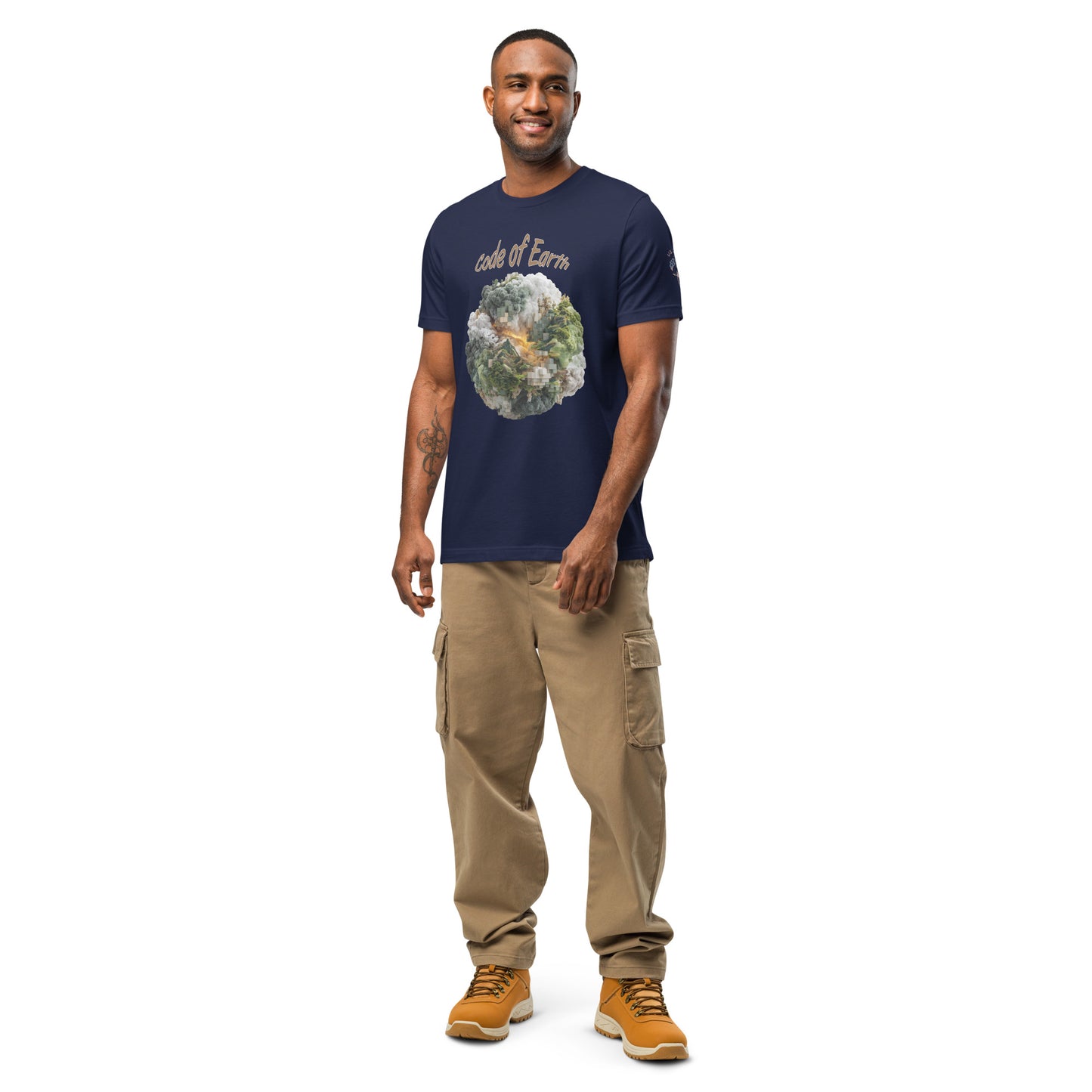 Product mockup. Smiling man in beige cargo pants and yellow boots, wearing a navy blue t-shirt with a digital-inspired “code of Earth” globe design.