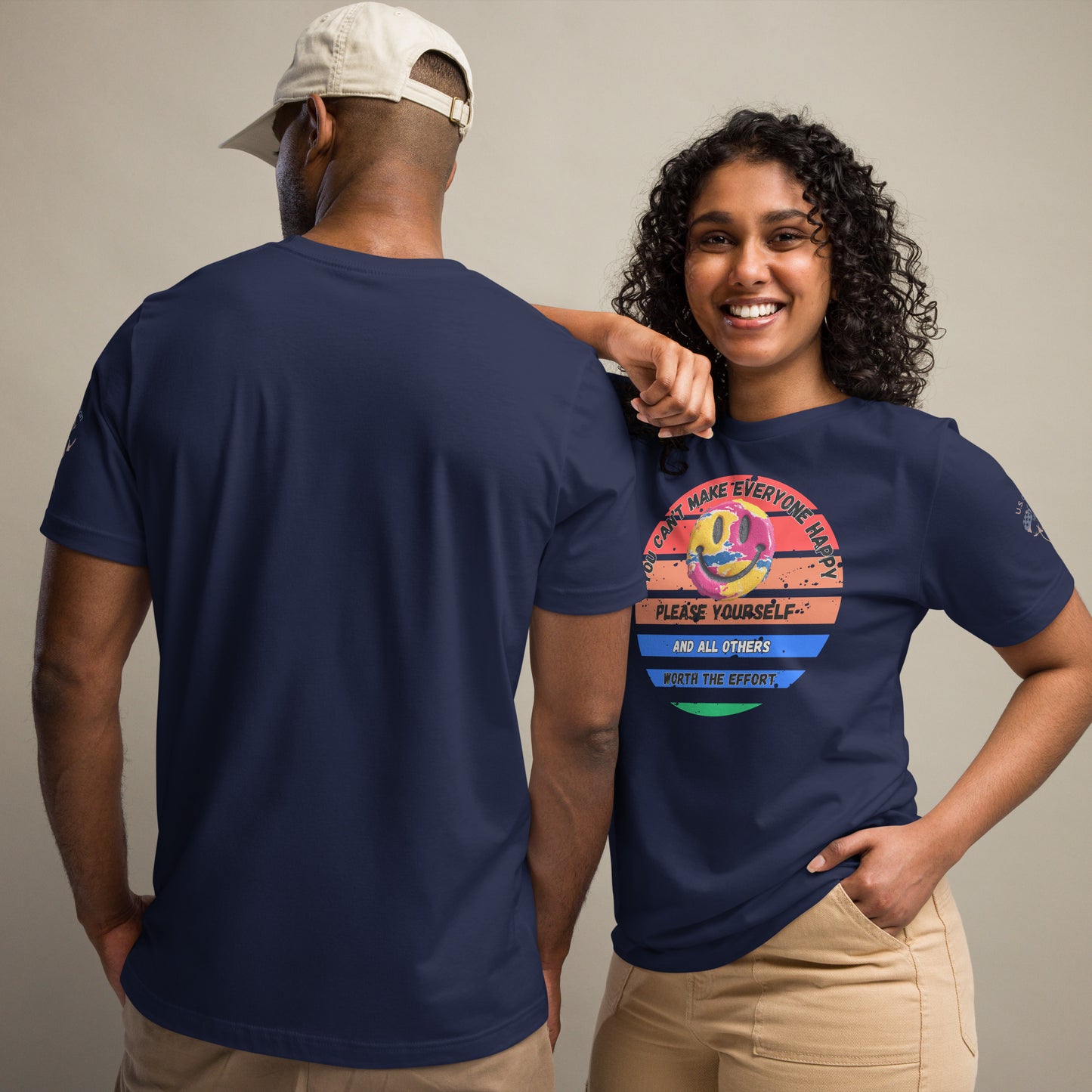 Product mockup. Man and woman: woman in beige pants and navy blue t-shirt with retro smiley face and positive text, man shown from behind in same shirt, man with back view.